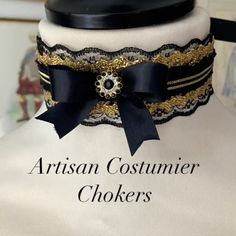 Beautiful 18th Century style lace choker made with black double faced black satin ribbon, the neckband has a black and gold braid running through the centre which is a gorgeous detail, trimmed with a vintage style black lace and gold lace which gives a layered effect, hand tied black ribbon bow with a black gem stone. The elegant choker is made with a half inch wide black double faced satin ribbon, running through the centre is a gorgeous black braid with two gold stripes at the centre is a hand Victorian Adjustable Choker For Formal Occasions, Victorian Style Adjustable Choker For Formal Occasions, Adjustable Victorian Choker For Formal Occasions, Adjustable Black Choker For Costume Party, Black Ribbon Choker As A Gift, Black Ribbon Choker Gift, Black Ribbon Choker For Gifts, Adjustable Black Steampunk Choker, Elegant Black Ribbon Choker