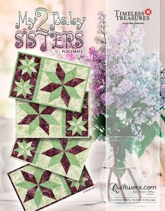 two baby sisters quilts are displayed in front of a vase with flowers and lilacs