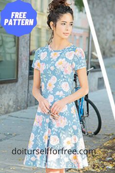 a woman is standing on the sidewalk with her hands in her pockets and looking off to the side