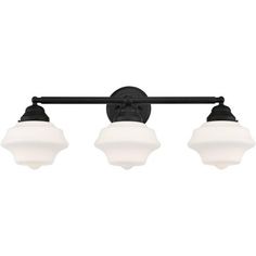 three light bathroom fixture with black finish and white glass shades on the top, in an old - world style design