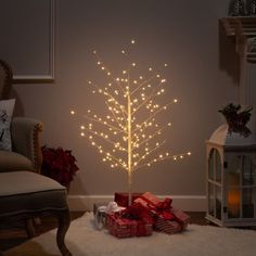 a lighted christmas tree with presents under it