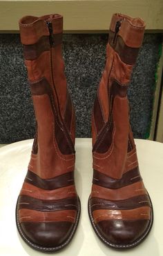 "Welcome! Vintage Leather Boots. Really original Design In good condition with some sign of use! Size 37 Made in Italy Brand: Walking On the World Measures: Heels: 2.75\" (7 cm) High boots: 9.05\" - 10.23\" (between 23 -26 cm) Thanks for stopping by!!IMPORTANT: Due to the delicate situation We're all going through, and in order to keep the safety of courier workers too, all orders will be dispatched when alert sanitary finished. You can purchased or reserve items like always. Thanks so much for Retro Wide Calf Leather Boots, Brown Wide Calf Heeled Boots With Round Toe, Retro Leather Heeled Boots With Wide Calf, Retro Leather Ankle Boots, Retro Wide Calf Leather Heeled Boots, Brown Leather Moto Boots With Pointed Toe, Brown Leather Lined Platform Boots For Fall, Retro High Ankle Leather Heeled Boots, Brown High Heel Boots With Wide Calf