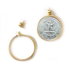 a gold ring with a coin attached to it