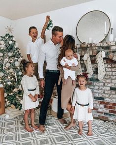 a family standing in front of a christmas tree