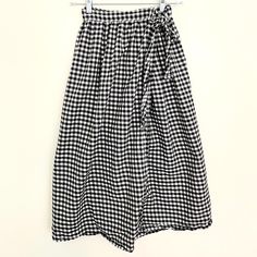 This is a lovely, light, size-inclusive wrap skirt, hand-made with 100% cotton. This is the perfect skirt for hot summer days and can be dressed up or down. Personally, I like to wear shorts while I bike to work in the summer, and then I throw this skirt on over the top. It's comfortable and stylish and has a lovely silhouette. Plaid Beach Bottoms For Spring, Plaid Bottoms For Beach In Spring, Summer Plaid Pleated Skirt, Summer Plaid Wide-leg Bottoms, Summer Plaid Wide Leg Bottoms, Summer Wide Leg Plaid Bottoms, Summer Tiered Skirt For Picnic, Spring Vacation Gingham Bottoms, Gingham Skirt For Summer Picnic