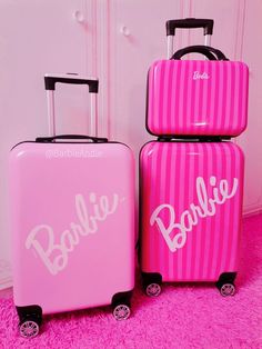 two pink suitcases sitting next to each other on top of a pink carpeted floor