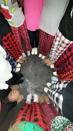 a group of people standing in a circle with their feet on each other's legs