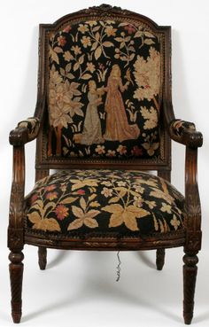 an antique chair with embroidered fabric on the back and arms, decorated with floral designs