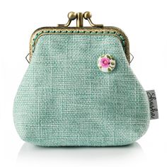 a green purse with a pink flower on it