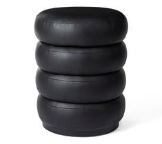 three black leather stools stacked on top of each other