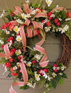 a wreath with red, white and yellow flowers