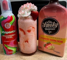 three different types of drinks sitting on a table next to each other, one with whipped cream and the other strawberry banana creme