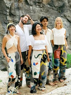 A functional work of art, tailored for you. Each pair of these batik pants is one-of-a-kind! Photos show suggested motifs, but your pair will be uniquely yours. With only 10 pieces made per year, you’ll own something truly exclusive. Size: LargeWaistband: 32" - 46"Inseam: 32.5"Mali (center front) and Adam (in blue Raglan Top) wear size L. Features:- 100% cotton: pre-shrunk, soft, breathable- Elastic waistband for extra comfort & fit- 4 Pockets: 2 deep front, 2 back- Secret pocket: fits cards, ca Hand Painted Clothes, Batik Pants, Unique Pants, Unique Photos, Tropical Prints, Batik Dress, Painted Clothes, New Pant, Pants Large