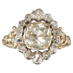 A French antique, Louis Philippe I period, cluster ring, in the Georgian style, set with a cushion cut, pale yellow, citrine, in a gold rub over setting, with an old mine-cut diamond surround, in silver, cut down, closed back settings, on a decorative gold shank, with carved shoulders, with a French eagle head mark, for 18ct gold, circa 1840. Louis Philippe, Eagle Head, Yellow Citrine, French Antique, Pale Yellow, Silver And Gold, Cluster Ring, Cushion Cut, French Antiques