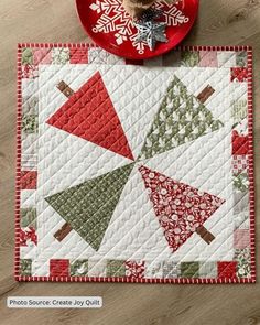 a red plate and some christmas decorations on a table