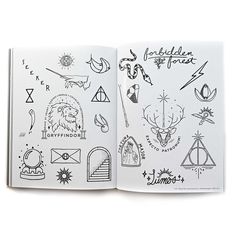 an open book with drawings and symbols on the pages, including harry potter's hogwarts