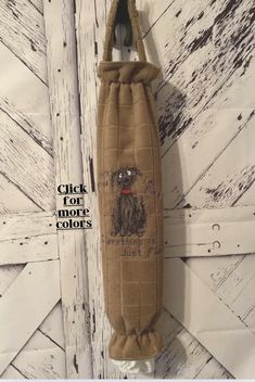 a bottle bag hanging on the side of a door with a dog drawn on it