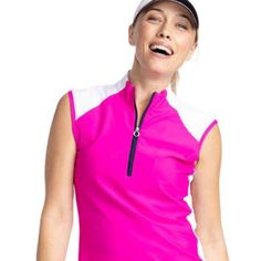 a woman wearing a pink shirt and white cap with her mouth open while standing in front of a white background