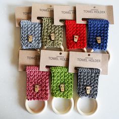 there are many different colored crocheted items on the table with price tags attached to them