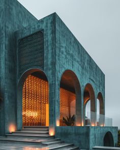 the entrance to a building that is lit up at night