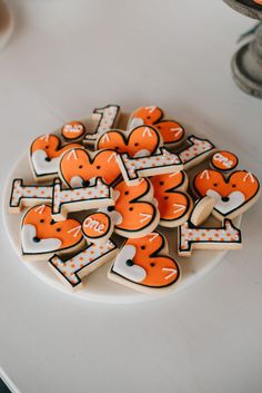 decorated cookies are arranged on a white plate