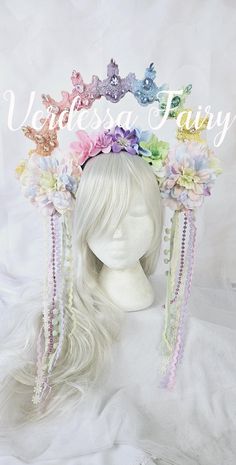 This pastel rainbow lace halo headpiece is a Rainbow Goddess halo crown. This pastel rainbow crown with an elevated lace halo is laden with sparkly stones and is a shimmering, glinting head turner. Mounted to a wide, toothed headband, this piece is easy to wear and comfortable, for those who can wear headbands. This piece is also TWO SIDED.  This means that either side can be worn as the 'front feature'.  One side of the floating halo is loaded with sparkly glass rhinestones, so it shimmers and glints as you move. On the other side of the halo, is a selection of small rainbow flowers, in colour order, to create a blossom like arch overhead.  A pretty selection of rainbow flowers rest underneath the halo and beads dangle each side of the face to frame.  This pastel pretty is READY TO SHIP f Whimsical Crown Headpiece With Matching Headband, Whimsical Crown-shaped Headpiece With Matching Headband, Whimsical Crown Headpiece For Carnival, Whimsical Tall Crown Headpiece For Carnival, Whimsical Carnival Crown Headpiece, Whimsical Teardrop Crown Headpiece For Festivals, Whimsical Adjustable Headpiece With Tall Crown, Whimsical Adjustable Crown For Festivals, Whimsical Adjustable Tall Crown Headpiece