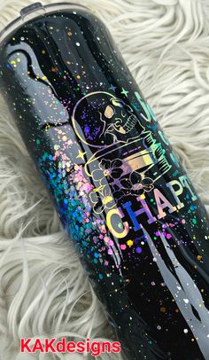 a black tumbler with colorful sprinkles and the words kaka designs on it