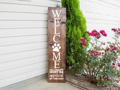 a wooden sign that says welcome to the dog