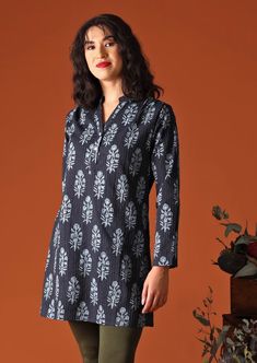 The Torvi Tunic Delphi is a sweet a-line shirt dress, crafted from 100% cotton, in a lovely navy blue traditional Indian print with small running "Kantha" stitches throughout the fabric. Kantha, a small straight running style of stitching found in Indian embroidery, adds texture and interest to the fabric. Featuring a mandarin collar, with functional buttons down the chest. Also features the gorgeous detail of small gatherings in front of the shoulders and at the back of the tunic. In the cooler Tunics With Leggings, Running Style, Navy Blue Print, Tunic Shirt Dress, Indian Prints, Natural Fibre, Indian Embroidery