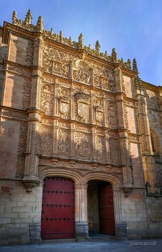 an old building with two red doors in front of it metal print by panoramic images