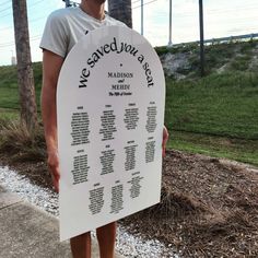 a man standing in front of a white sign