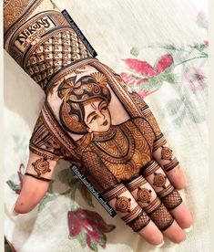 the hand is decorated with henna designs on it