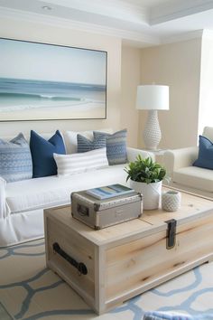 a living room filled with furniture and a painting on the wall above it's coffee table