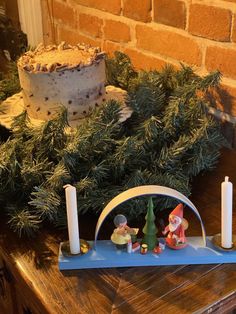 a christmas scene with candles and decorations on a table