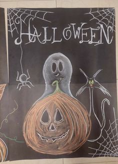 a chalk drawing of a halloween pumpkin and ghost