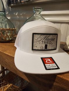 White Trucker Hat One Size Fits Most, White Trucker Fitted Hat, White Trucker Hat, One Size Fits Most, White Adjustable Trucker Hat With Curved Bill, White Adjustable Curved Bill Trucker Hat, White Trucker Hat With Curved Brim, White Trucker Hat With Flat Bill, White Adjustable Hat With Curved Bill, White 5-panel Snapback Hat Casual