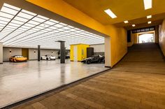 an empty parking garage with two cars parked in the space between it and another car on the other side