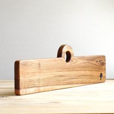 a wooden cutting board sitting on top of a table