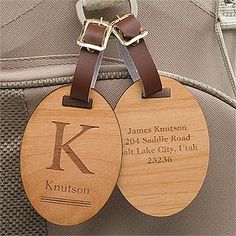 two wooden luggage tags attached to a backpack