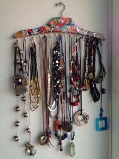 a bunch of necklaces hanging on a wall