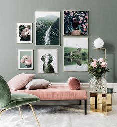 a living room filled with furniture and pictures hanging on the wall above a pink couch