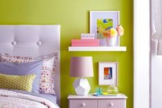 a bedroom with green walls and white furniture