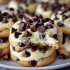 chocolate chip cookies with white frosting and chocolate chips on top are arranged on a plate