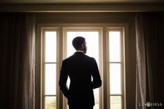 a man standing in front of a window