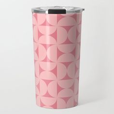 a pink travel mug with circles on it