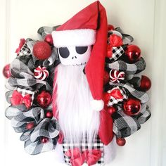 a wreath with a skeleton wearing a santa hat