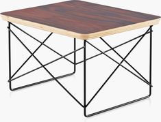 a wooden table sitting on top of a metal frame