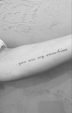 a woman's arm with the words you are my sunshine written on it, in black and white