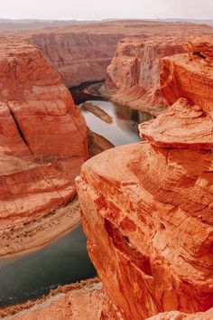 a river running through a canyon surrounded by red rocks