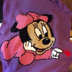 a knitted minnie mouse sweater with an apple on the chest and heart at the bottom